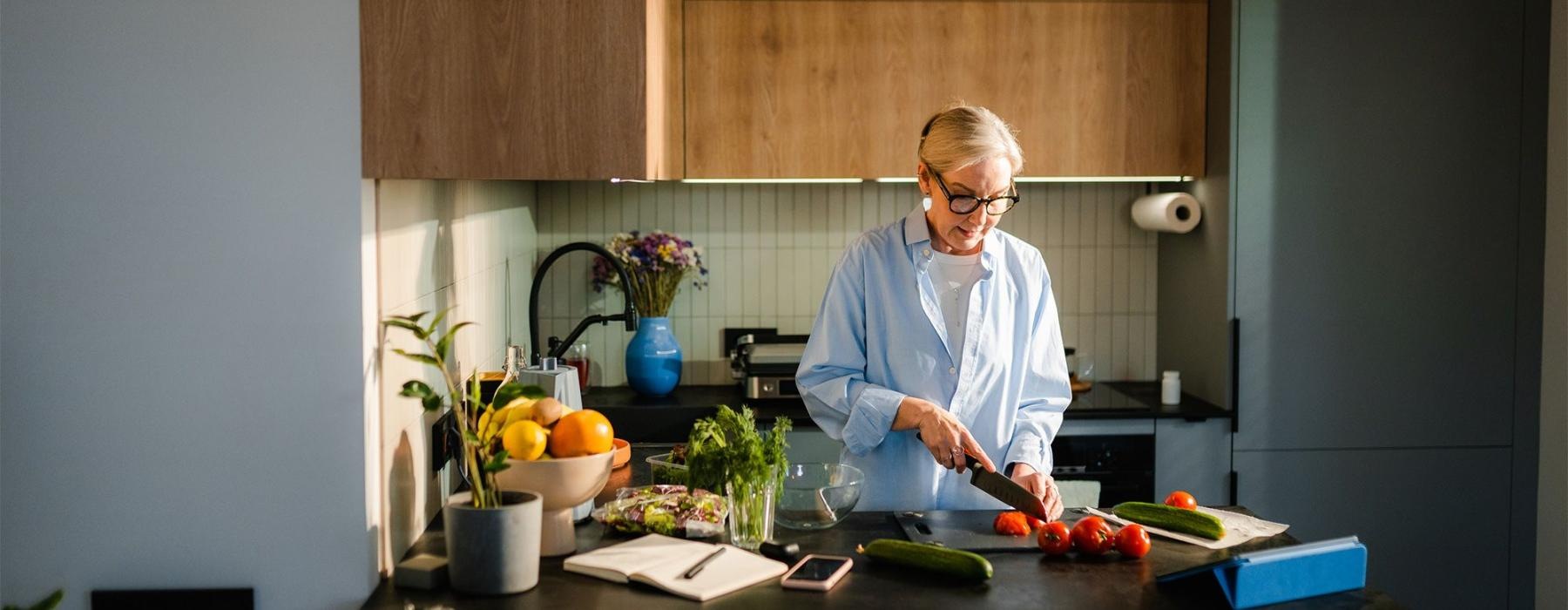 a woman cutting vegetables in the kitchen